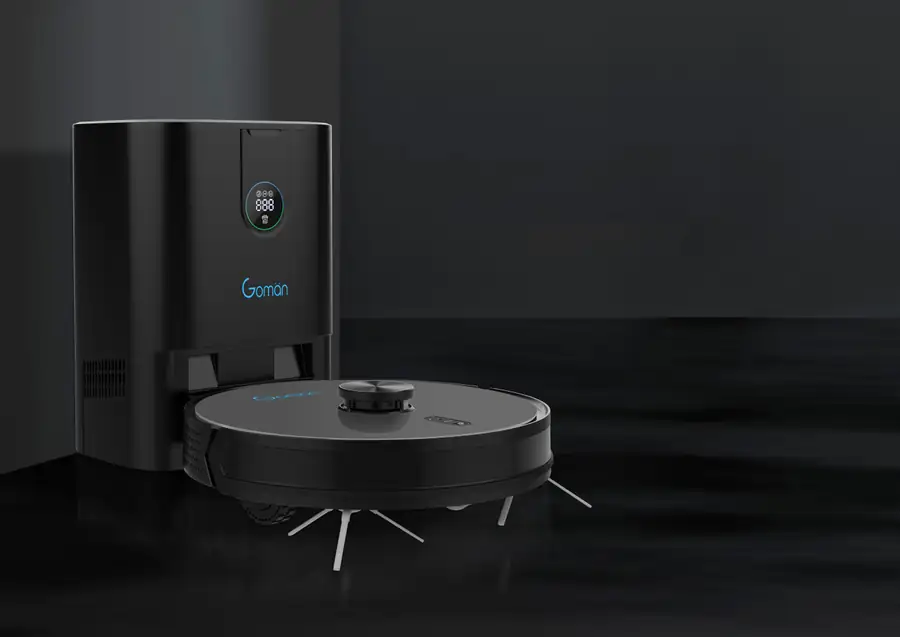 Robot aspirador redondo junto a su base de carga, sobre suelo oscuro